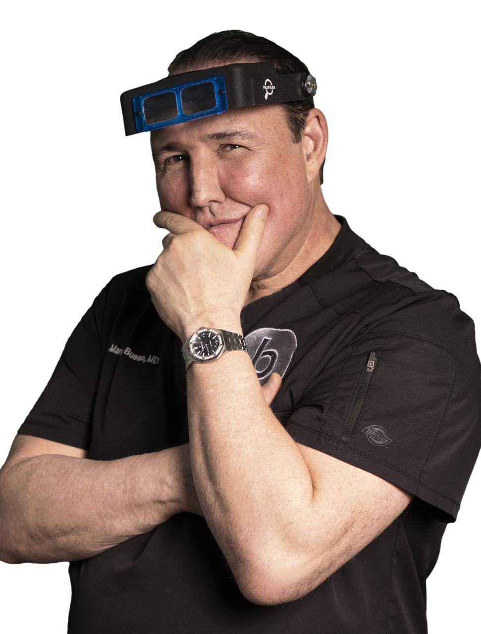 Dr. Mariano Busso in black scrubs, resting his chin on his hand