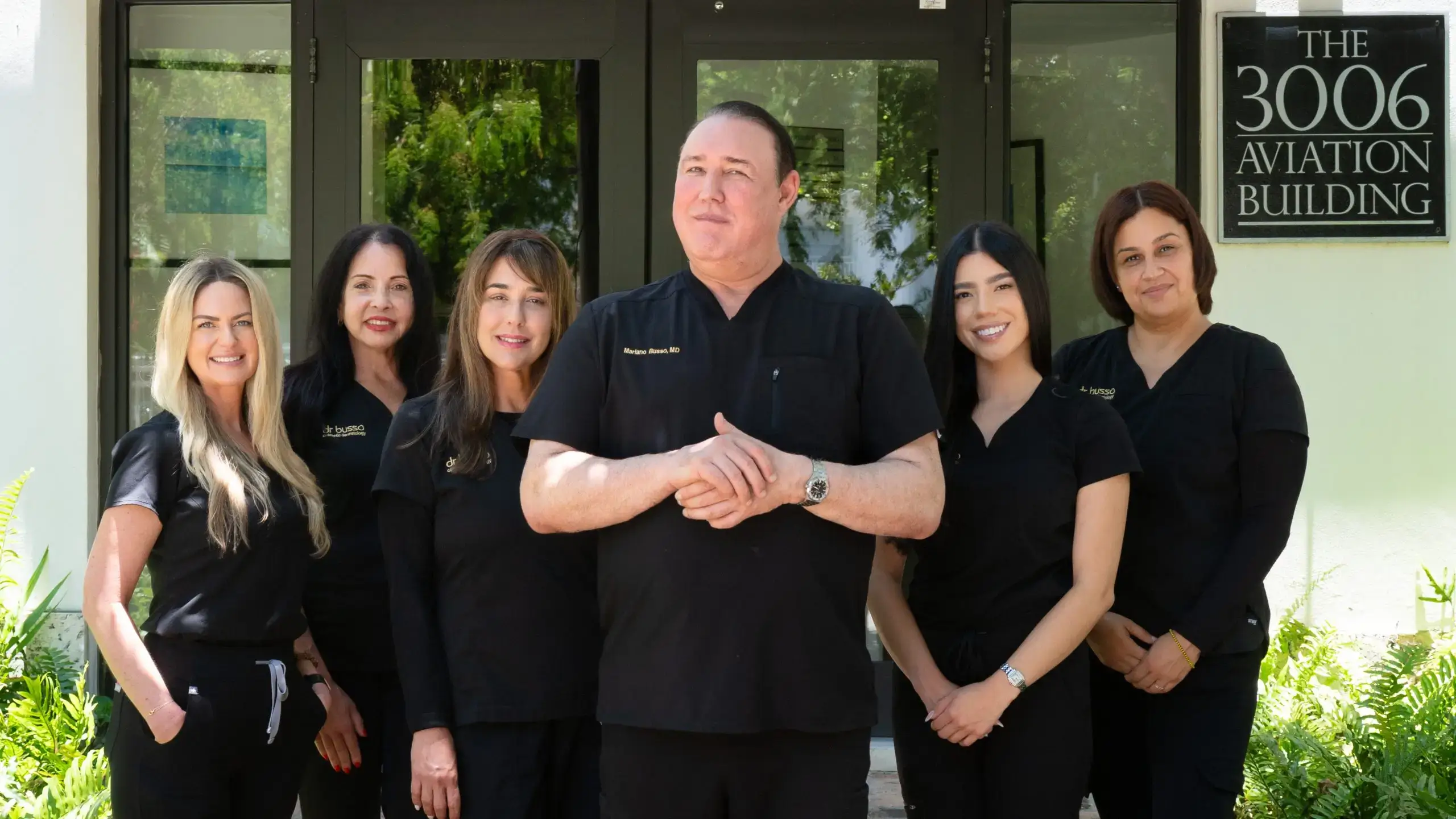 Dr. Busso and five members of his team standing in front of the 3006 Aviation Building in Coconut Grove